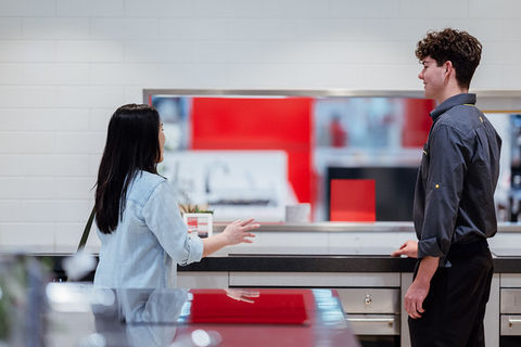 Woman and man at counter, interacting with each other, careers.