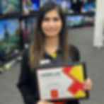 Smiling woman holding certificate; certificate reads 