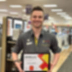 Smiling employee holding certificate with 